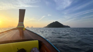 Heading to Koh Ngai at sunrise on a private longtail